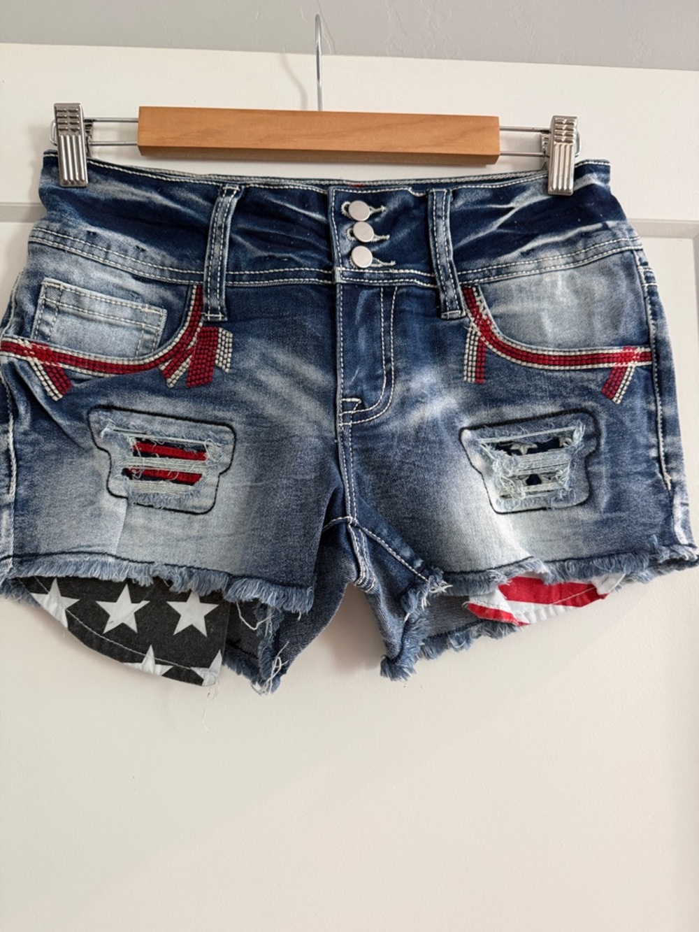 Women's Blue Distressed Denim Shorts with Patriotic Patch Accents